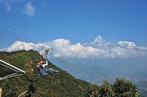 Photo of two people zip-lining in Pokhara