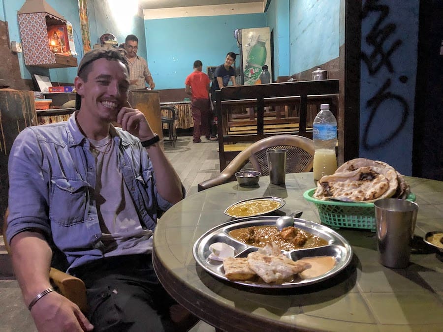 Hayden eating local food while at a restaurant in Kathmandu